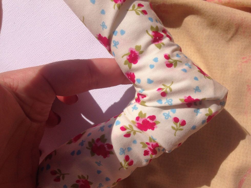 Attach the fabric using drawing pins. Making sure each corner is folded into a v shape.