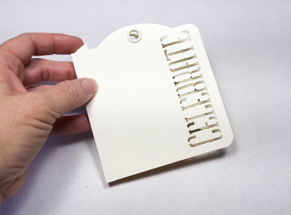 Attach the front tag to the inside of the scores spine as shown.