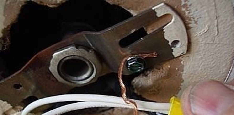 Attach the ground wire to the ground screw and then screw and mount the new light fixture onto the wall.