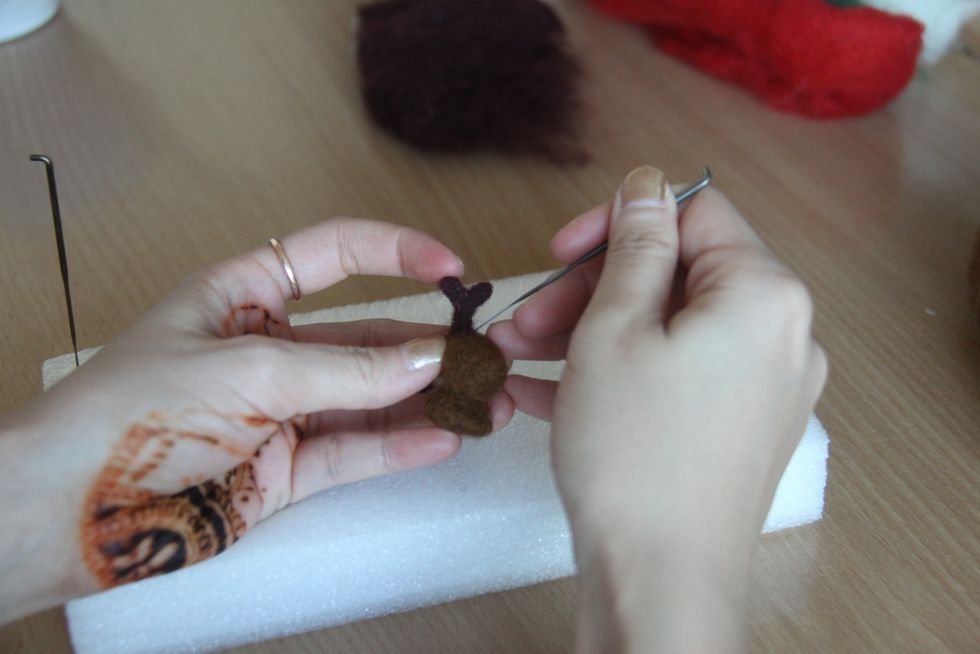 Attach the horns to the head.