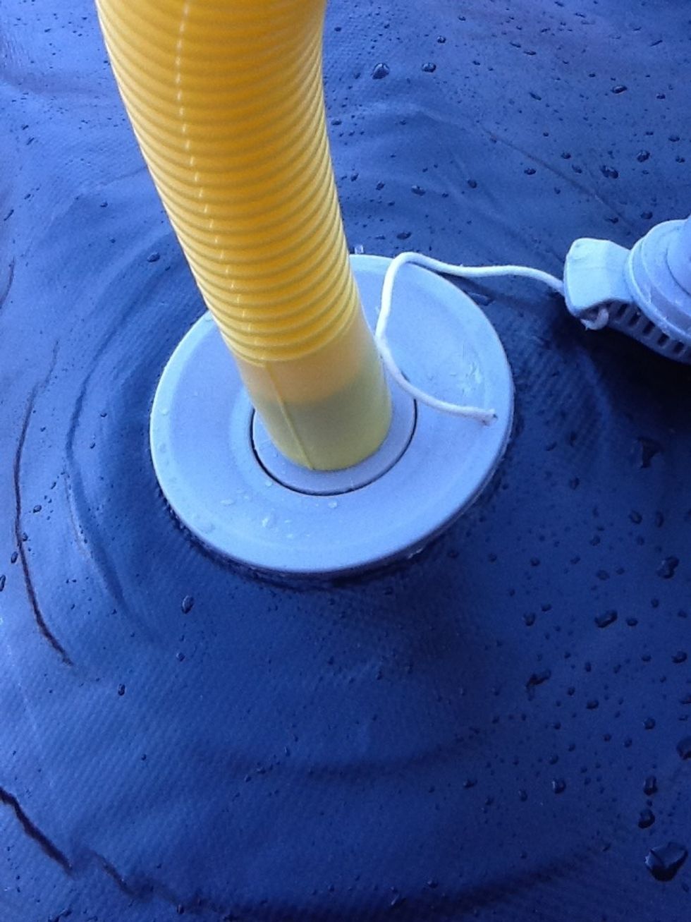 Attach the hose to the valve by pushing down and clockwise. You need a tight seal, so if you can't get one add a thin rubber washer. And if it won't go in, consider using a thinner washer or fewer.