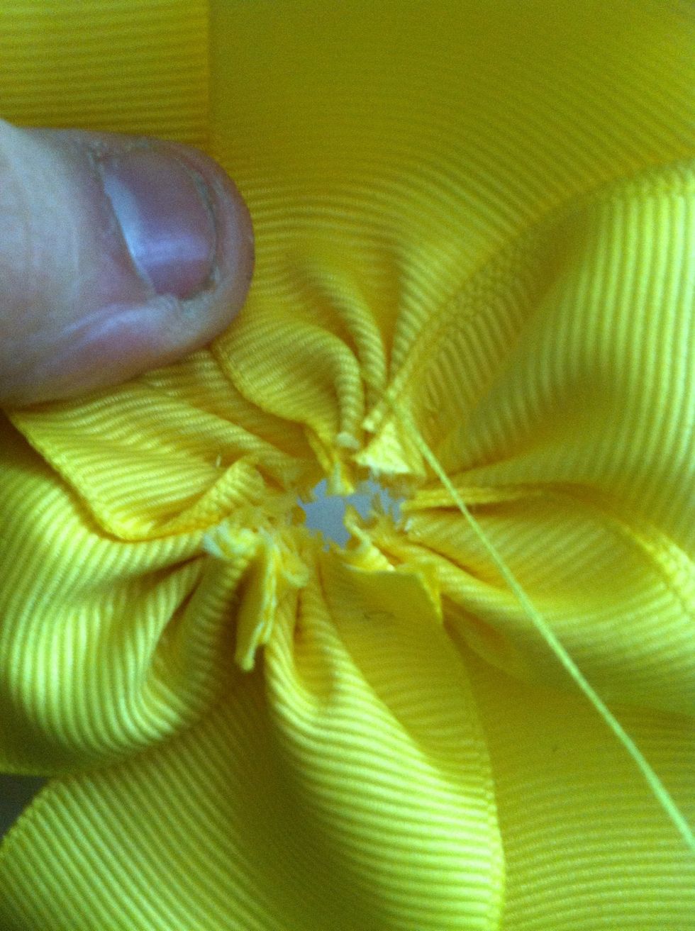 Attach the last petal to the first, continuing with the overlapping pattern of the previous petals. Throw a few random crisscrossing stitches in to secure it.
