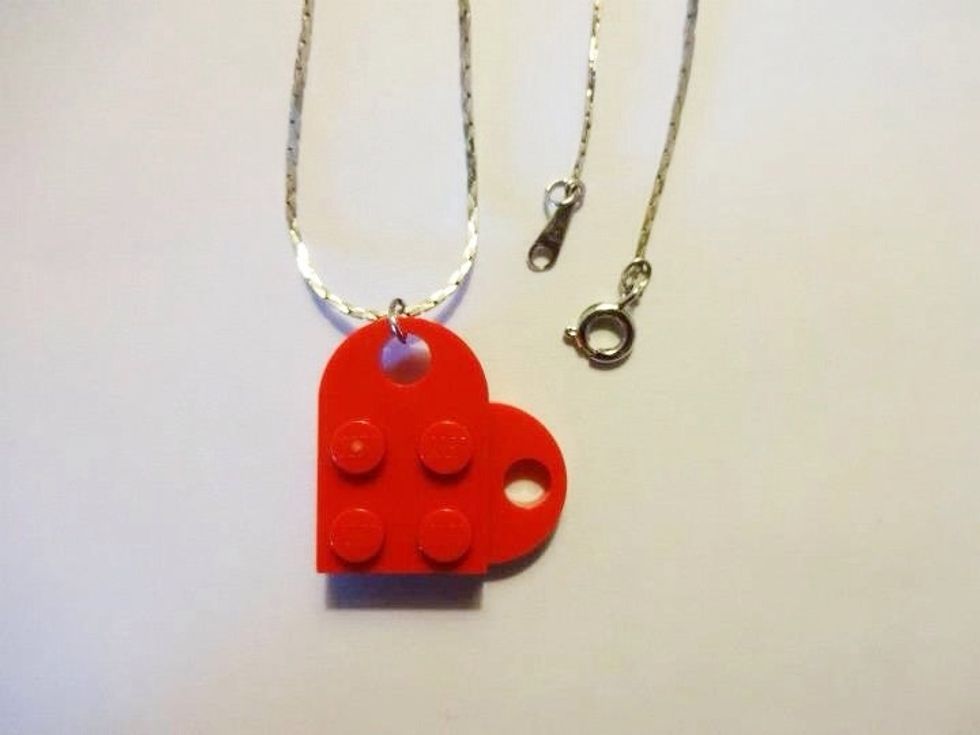 Attach the Lego heart to the jewelry chain using a jump ring. If you don't have a jump ring, you could use a thin piece of ribbon and tie it in a bow.