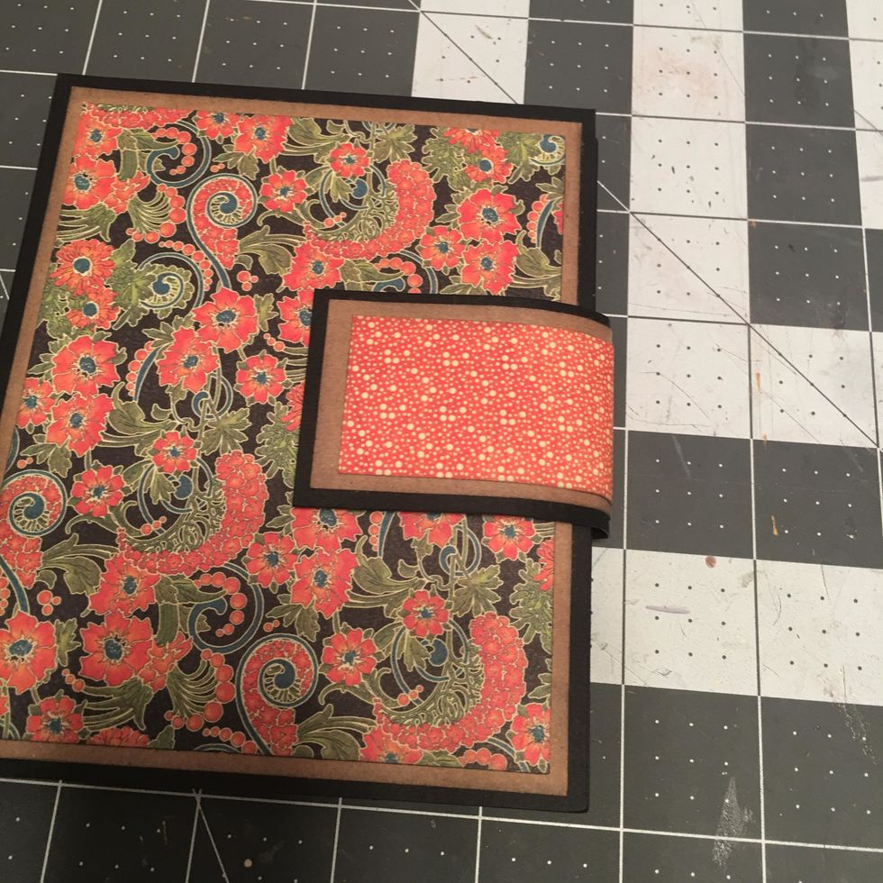 Attach the magnet side of the closure to the front cover and GENTLY curve and bend the closure piece toward the back of the album.