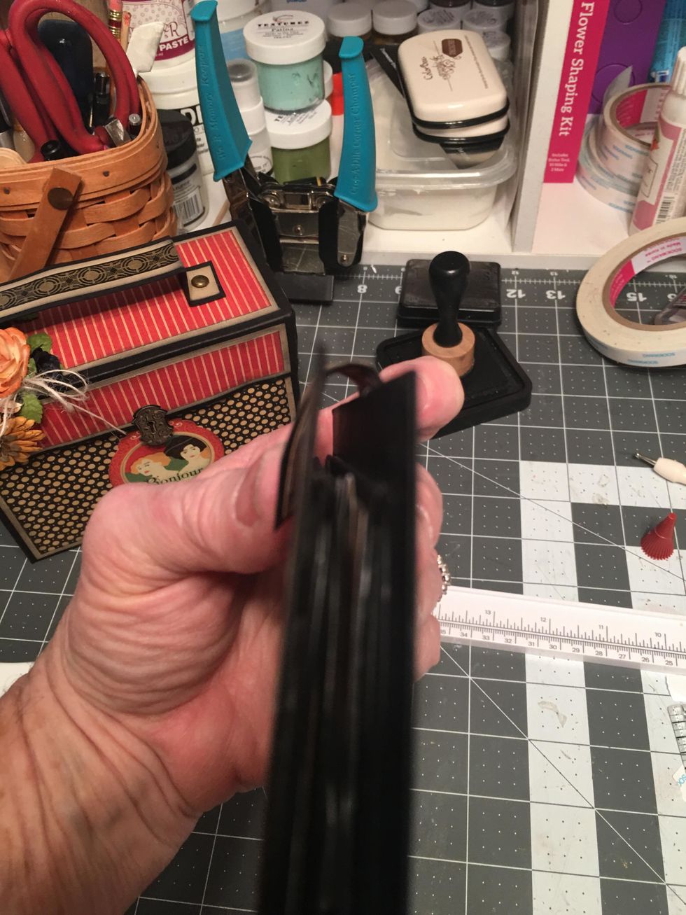 Attach the magnet side to the front and curve again and attach the scor-tape/glue end to the back of the album.