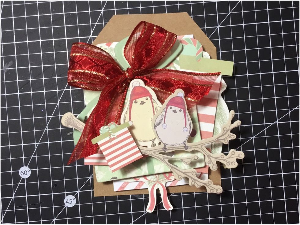 Attach the other smaller fussy cut present into the background, as shown.