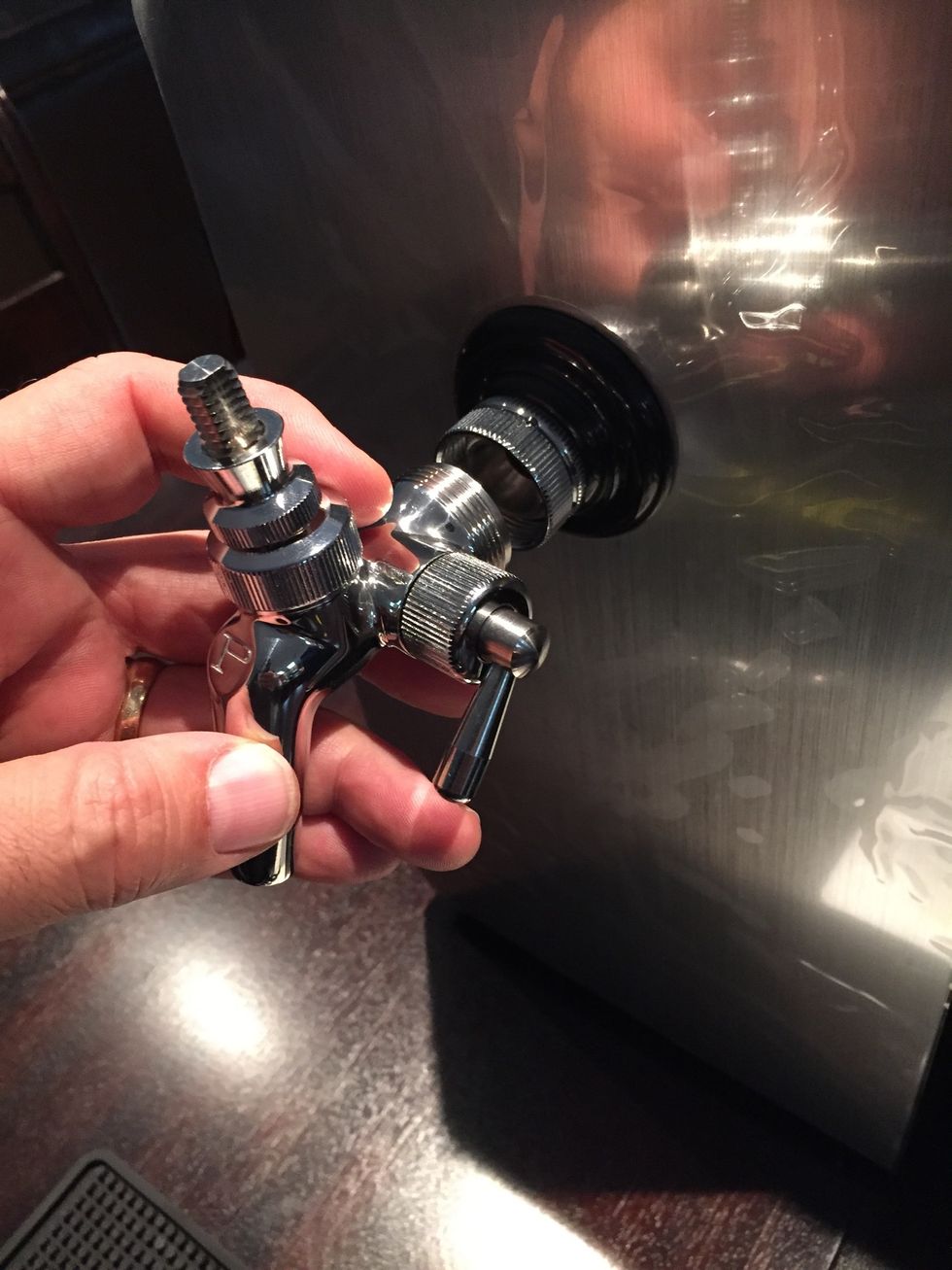 Attach the pour spout. If you open the door you can also tighten the spout from the back to keep it from tilting to one side.