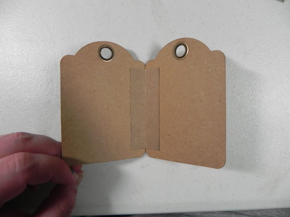 Attach the second tag to the hinge, flush to the edge lining both tags up evenly. Then repeat until all tags are attached.