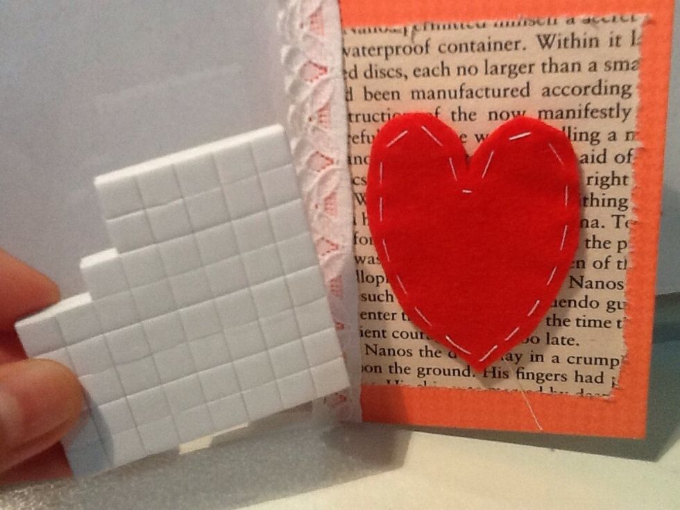 Attach the sewed, red felt heart onto the front using adhesive squares.