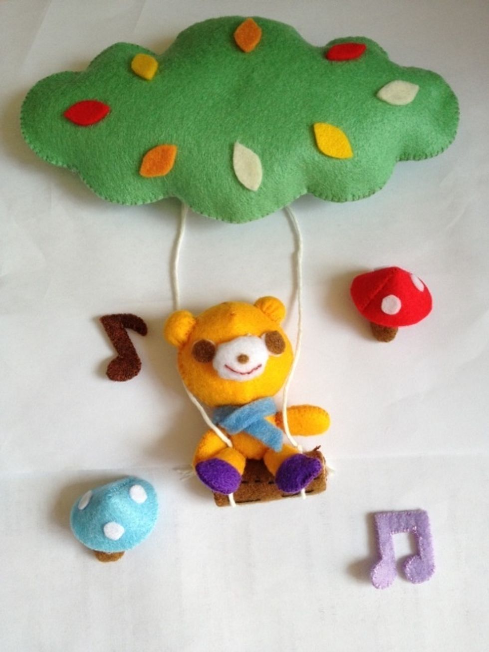 Attach the tiny bear to the wood, also arms and eyes on the strings with only three stitches to hold the bear from falling off the wood! *o*