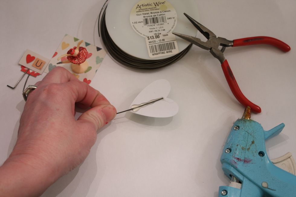 Attach the wire to the backs of your stickers or die cuts with hot glue and let cool. I used three wires, three different sized pieces and made them 3 different heights