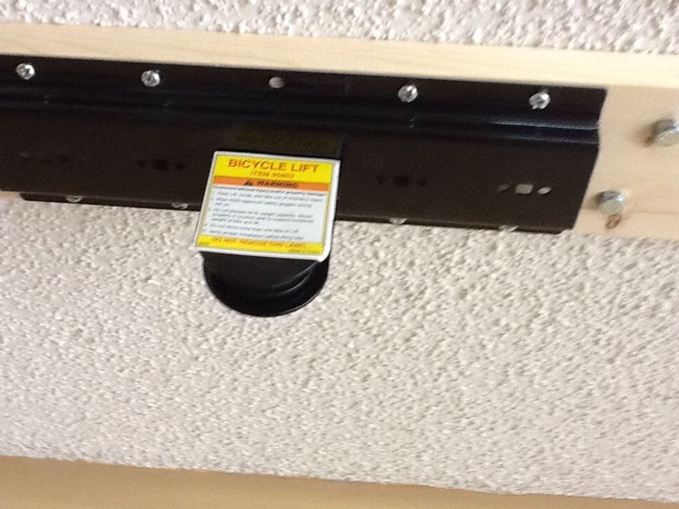 Attach this rear lift bracket as shown with at least 8 wood screws about 2 inches long.
