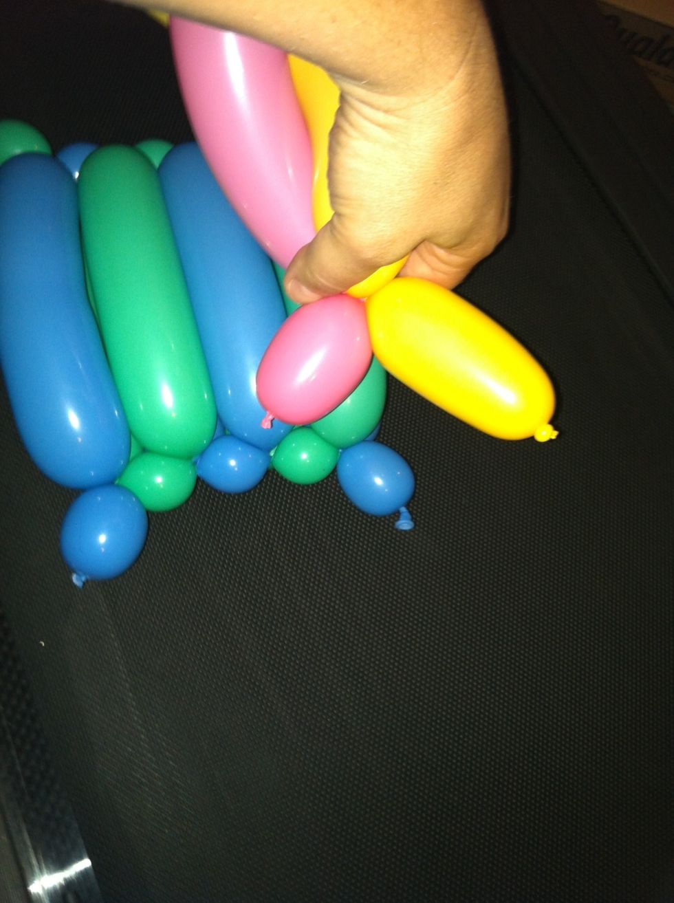 Attach to one of the little bubbles hanging off the flat weave