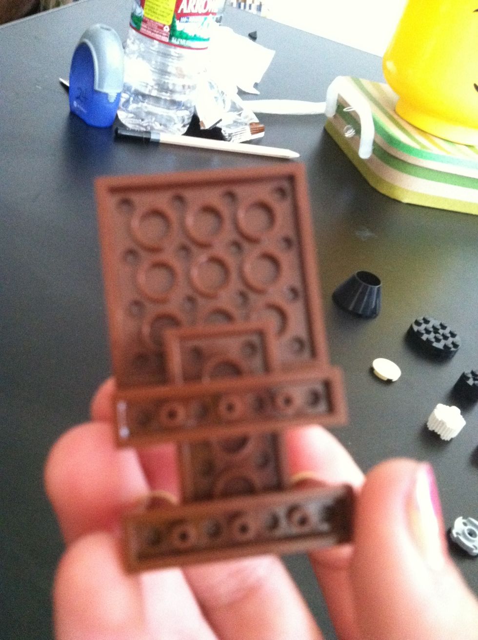 Attach two 4 holed brown pieces for arms and legs, now attach the hands to them