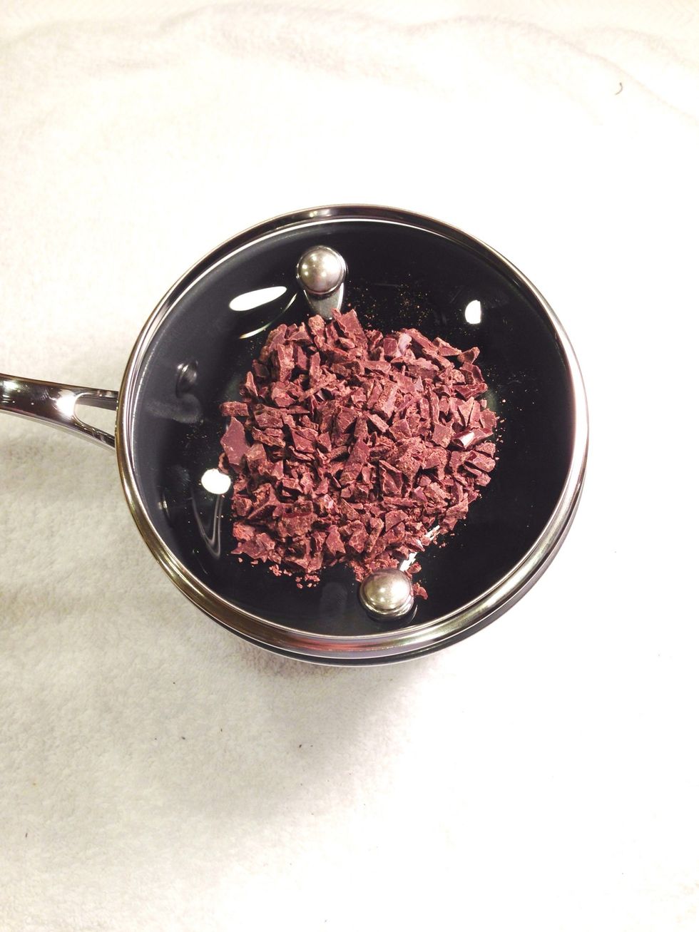 Avoid melting the chocolate over direct heat. I added a few cups of water in a pot, flipped the lid, poured the chocolate on the bottom side of the lid, and set it over high heat.
