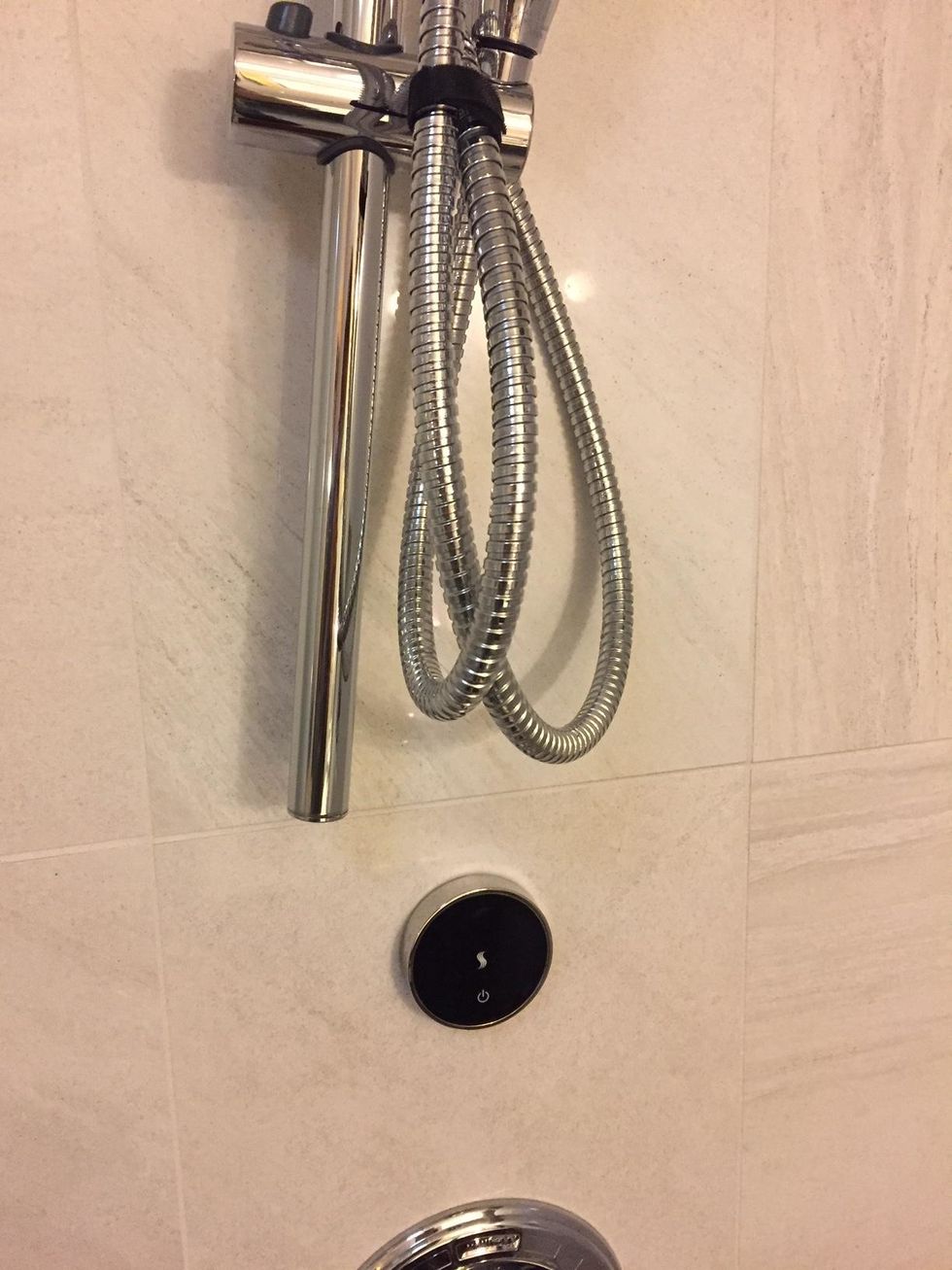 Avoid the metal hose toucher the steam shower controller. (You may have to reset the system as shown in the previous step if it does)