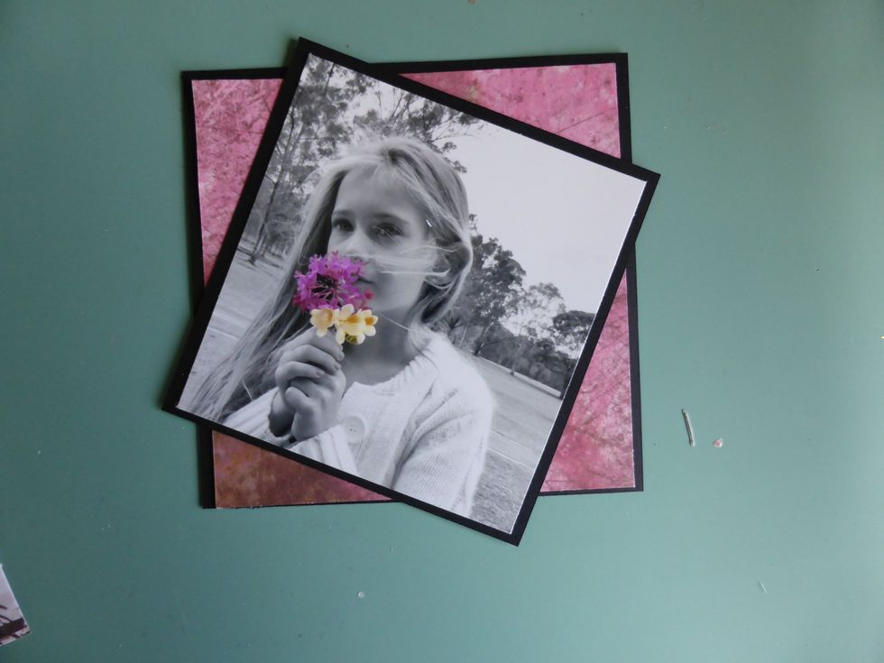 Back a 4x4 photo onto black cardstock, and layer this on an angle onto a square of Sweet Souvenirs paper also framed with black cardstock. .