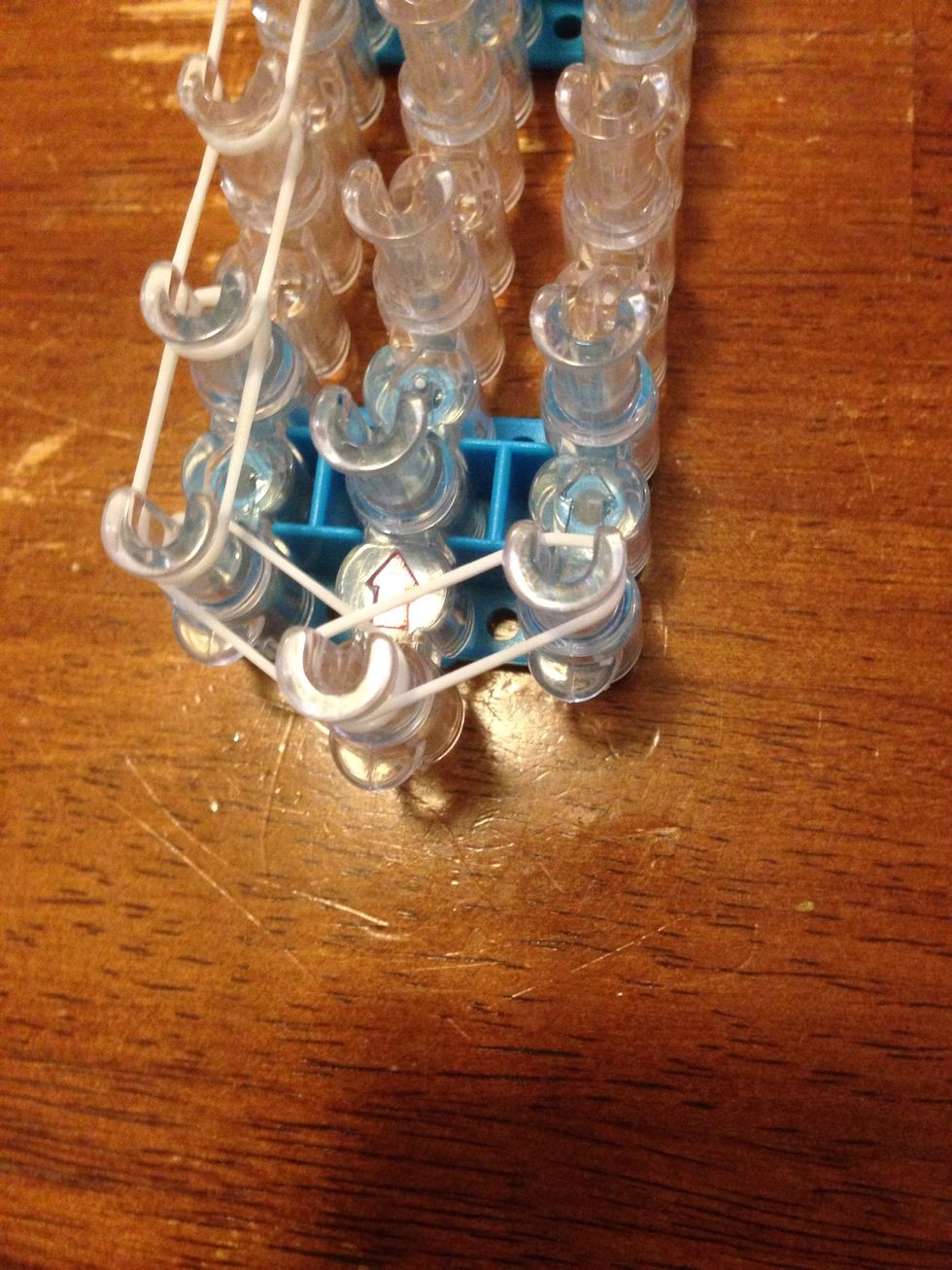 Back at the bottom, put a band from the first middle to the first right pin.