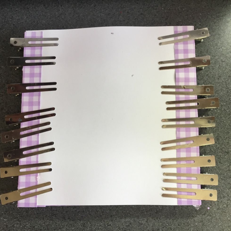 Back of card, clips holding backing card in place whilst glue dries.