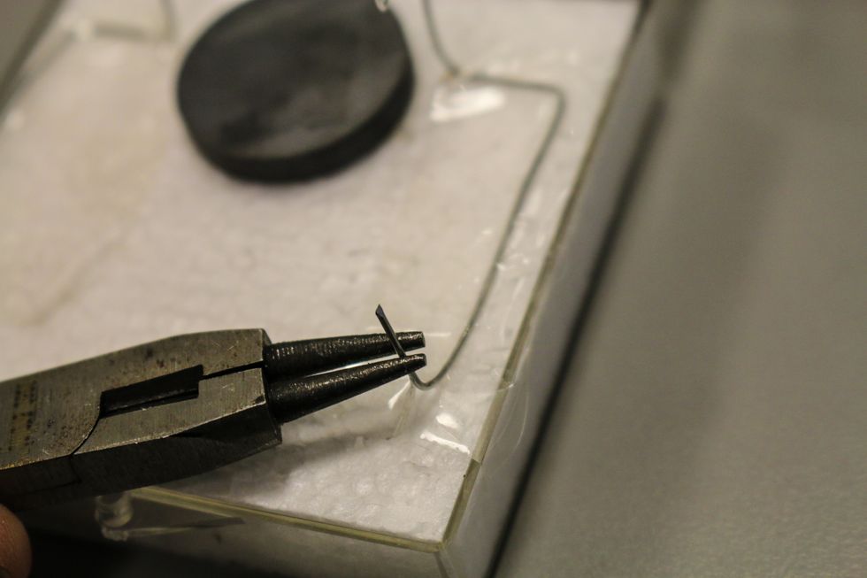 Back on the hook wires you are going to bend up their ends. These will be touching either side of your battery.