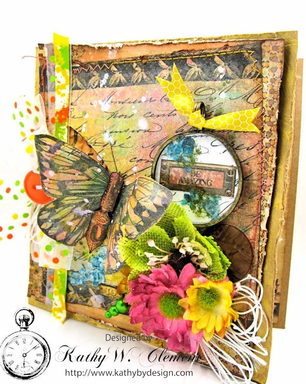 Back the optical lens with a scrap from the mixed media paper.  Fussy cut library drawer from Ordre du Jour and place on top.  Add mica chips. Top with honeycomb print ribbon. Secure with foam tape.