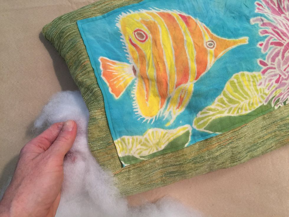 Back the pillow with another piece of decorative fabric. It doesn't have to be the same fabric; it could be a fun contrast to the front. Stuff it with Polyfill.