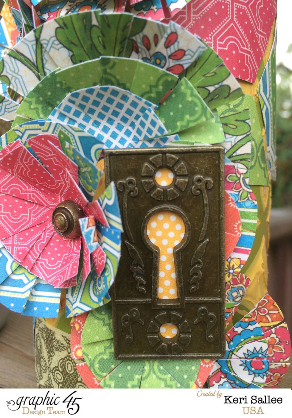 Back to the large bottle! Layer your flowers in a way to allow your background to peek threw. Add a Graphic 45 Ornate Key Hole (I backed it in yellow to make it pop!)