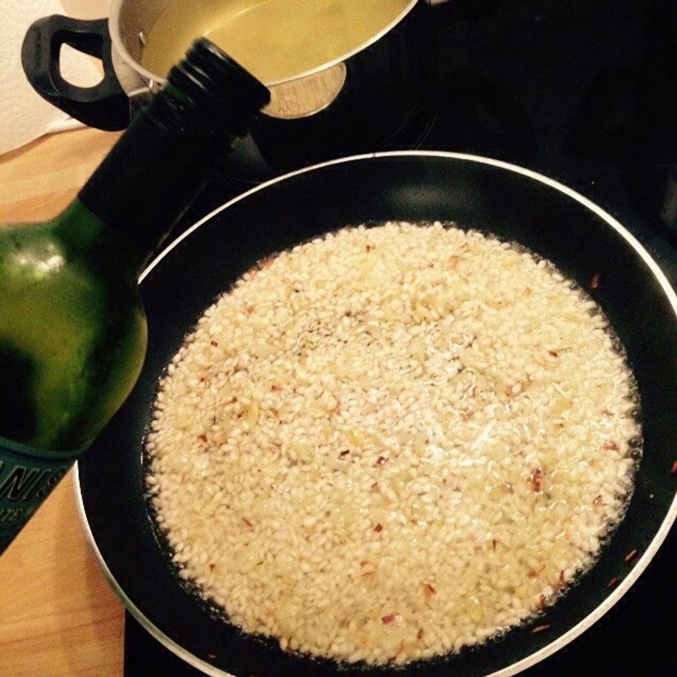 Back to the rice now, when it's toasted add the white wine and turn up the heat to let it evaporate.