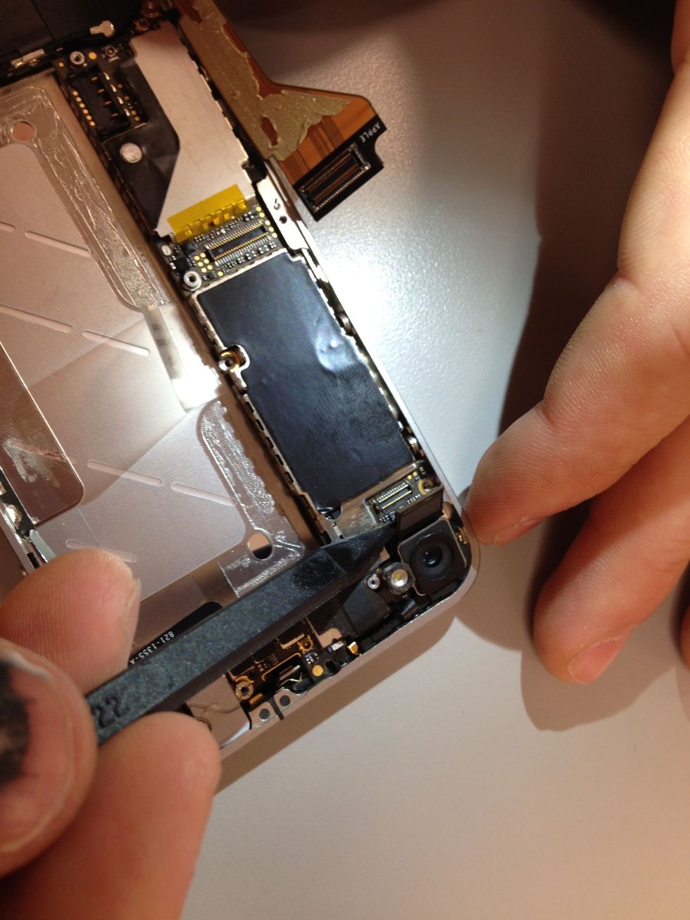 Back towards the top corner now, remove the camera connector cable and carefully take out the camera.