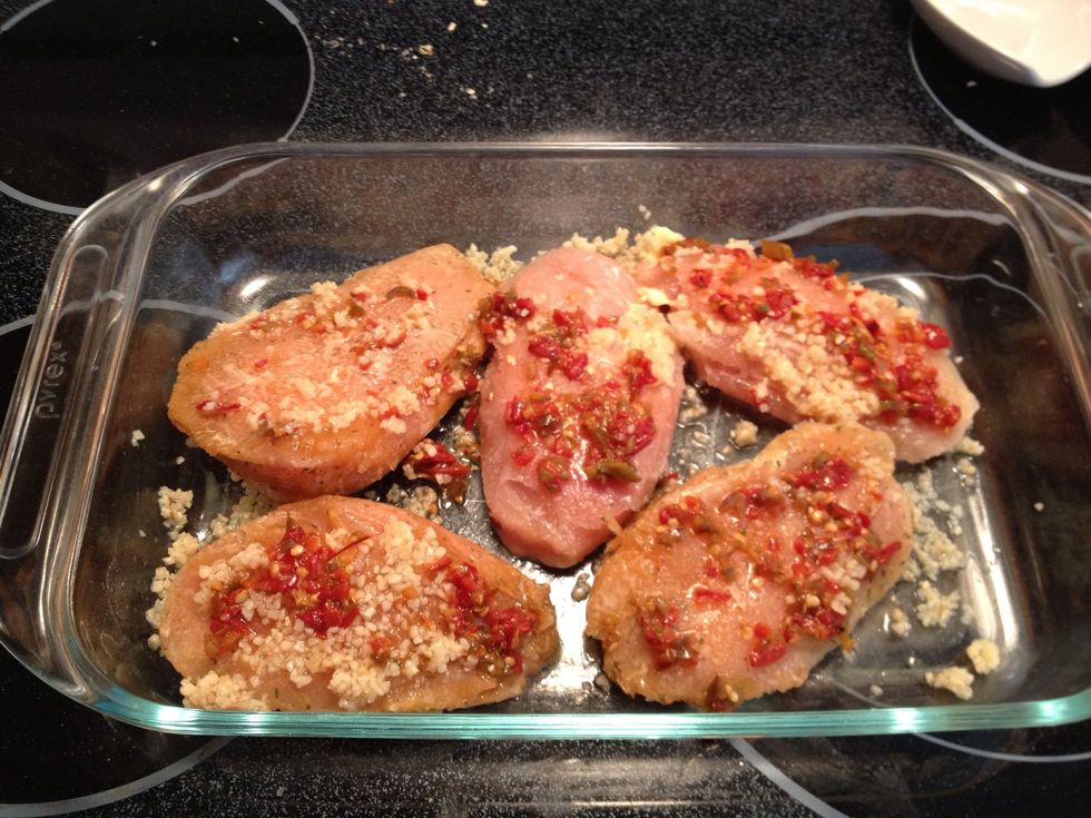 Bake (5) chicken breasts layered with minced garlic and optional spices (I used jarred diced chilis). Ovens may vary but I baked this chicken at 400 degrees for 20-30 min