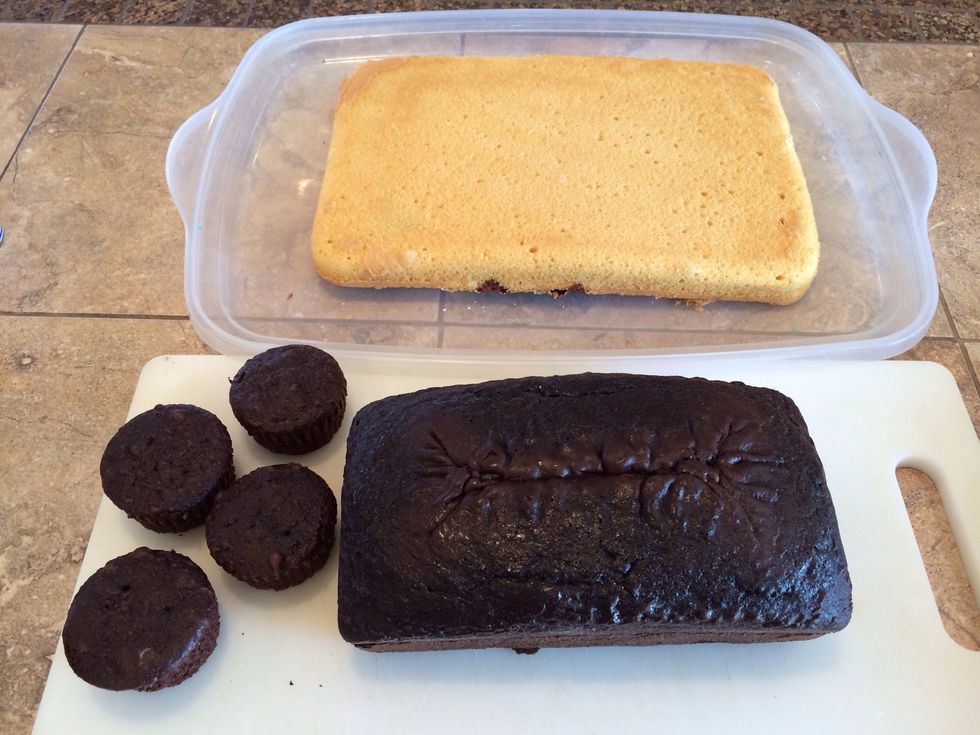 Bake a 9x13" cake for a base (I did a marble cake), and another in a loaf pan (I did chocolate), making some batter into 4 cupcakes. I like to freeze them before working with them.
