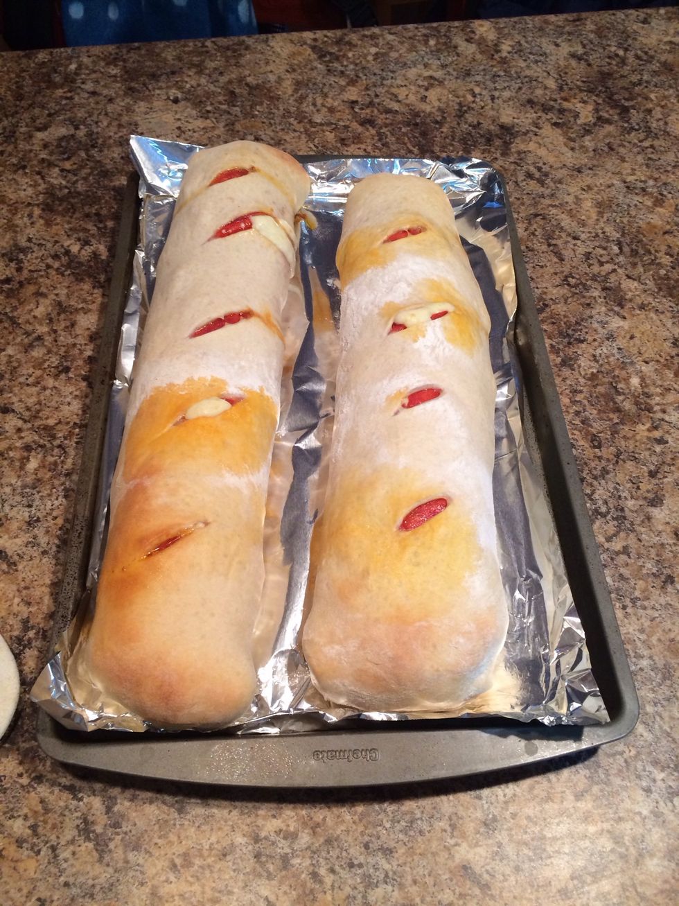 Bake at 350-375 for about 15-20 minutes. I baked these at 365 for 20 minutes. Until the crust was golden on the end. You can also brush on some melted butter before baking to brown it a little more.