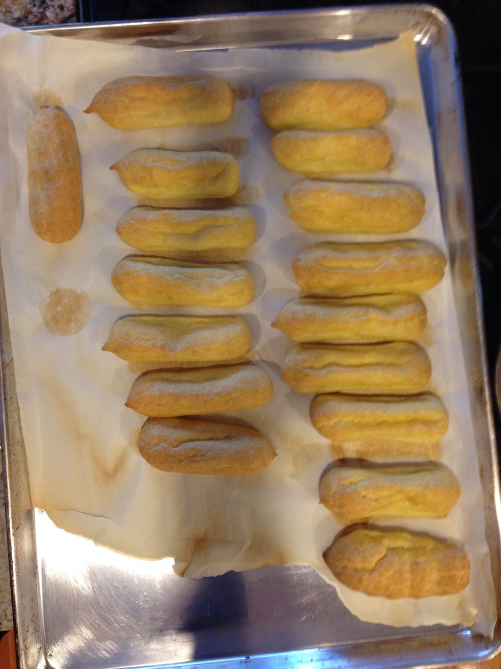 Bake for 15 min at 450 degree F. Then lower oven temp to 325 and bake for another 20 min. Immediately poke small holes in either end of the baked eclairs, to let the air out and prevent sogginess.