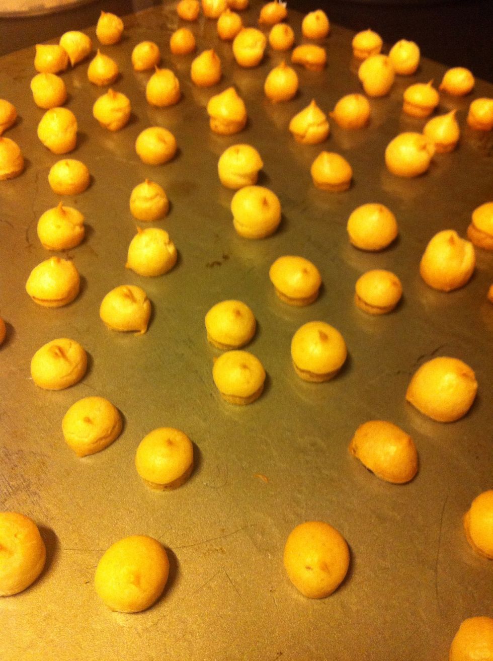 Bake for 7 minutes at 220 degrees celsius and then lower the temperature down and further bake at 180 degrees Celsius for 5 minutes, or until the puffs are crisp.