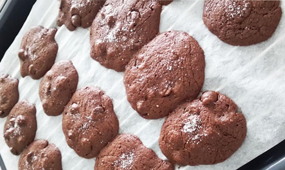 Bake for 8-10 mins. Cookies should be slightly darker brown around the outside. Remove from oven, sprinkle a little bit of sea salt on top of each cookie and leave to cool.