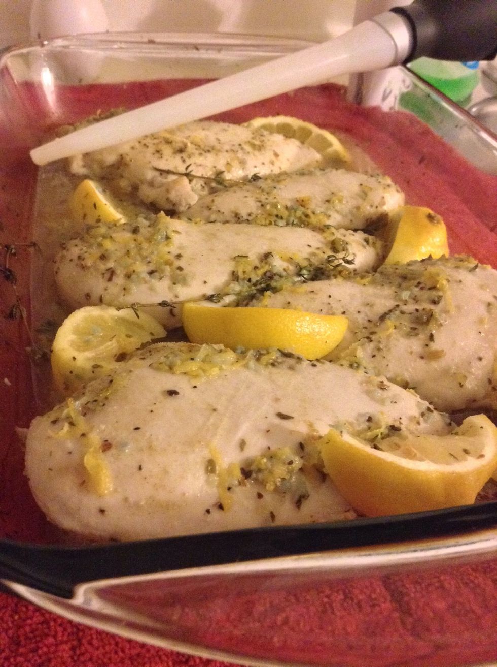 Bake for about 15 minutes and then pull your chicken out and baste your chickens. If you dont have a baster just grab a spoon and scoop up as much of the sauce as you can and pour it over the chicken.