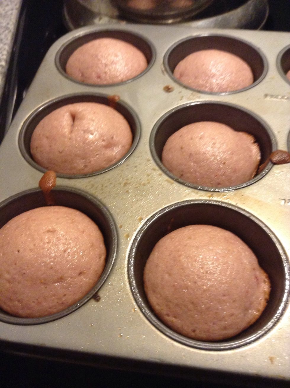 Bake for at least 18 minutes. To check if they are done, stab with a knife/toothpick. If there's anything left when you pull out the knife/toothpick than they need more time. Let them cool when done.