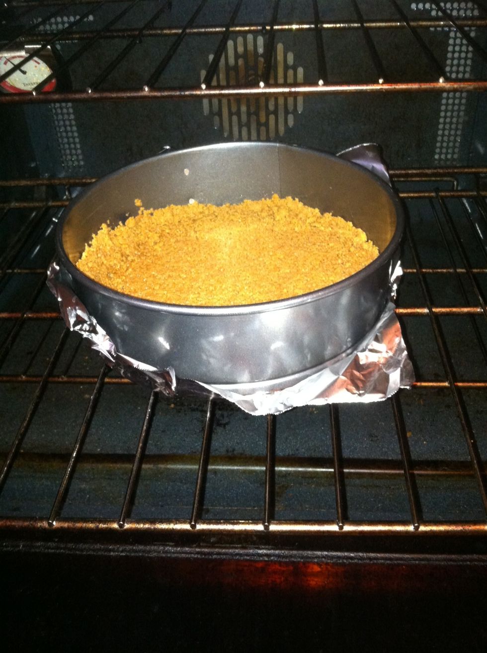 Bake in 350 degree oven for 10 minutes. Have tin foil wrapped around pan during the whole process of baking the cheesecake to avoid oven spills.