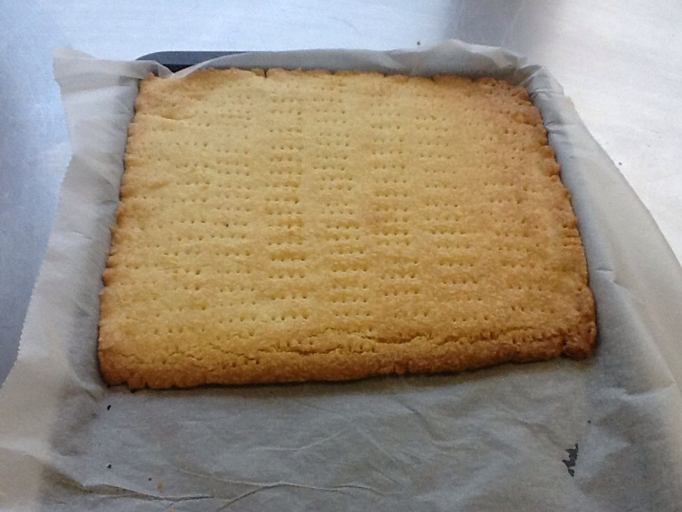 Bake the shortbread in the pre-heated oven for about 20 minutes or until firm to the touch and very lightly brown. Let it cool in the tin