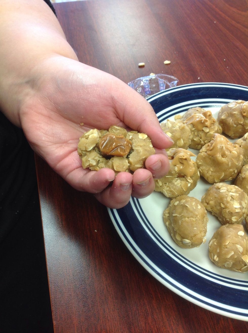 Ball cookies and add caramel in middle
