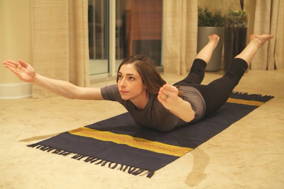 Banana Boat Part II: Lift legs, arms, and chest off the ground. Hold for ten seconds then roll back over, alternating the direction you roll. Do this three times (60 seconds total)