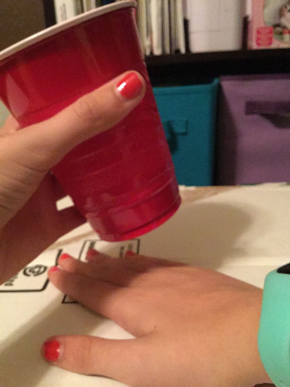 Bang your right hand on the surface, still holding the cup in your left hand.