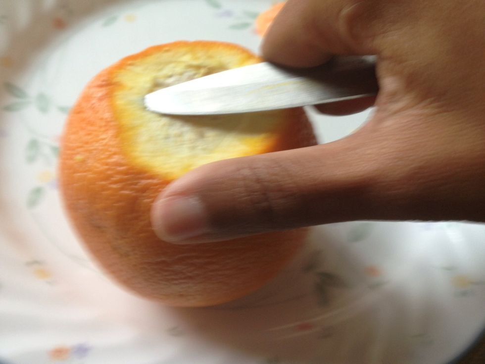 Barely separate the peels from the pulp at one end using a knife as shown.