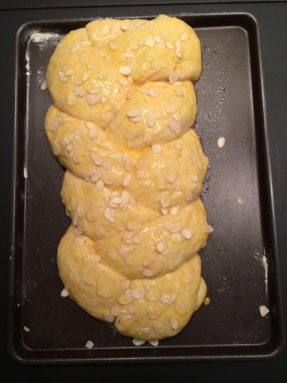 Baste the risen dough with the egg yolk, sprinkle with slivered almonds and re baste over the almonds pressing lightly