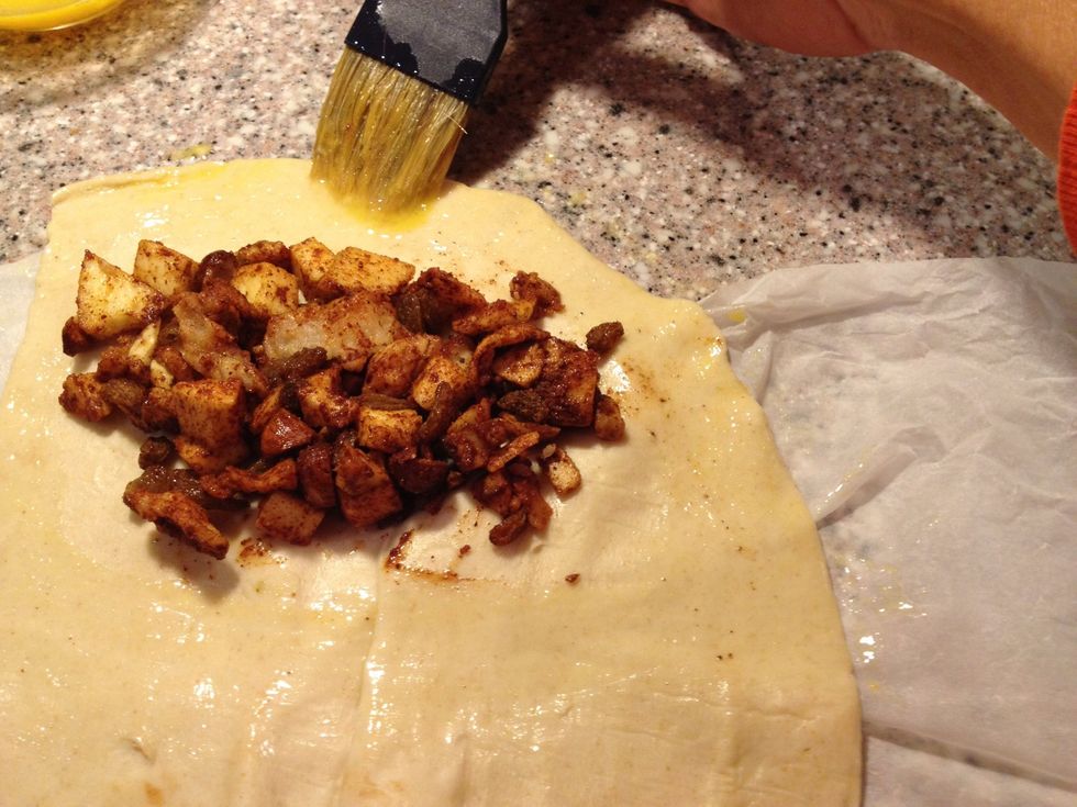 Baste with an egg alongside the pie dough to make it stick.