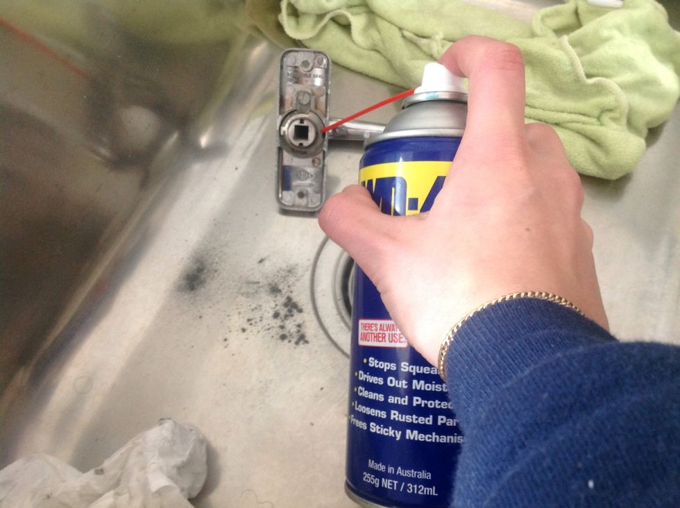 Be generous. And then start using the handle, while still in the sink. This way you are spreading the lubricant around and any drips are not running down your door.