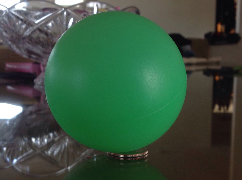 Be sure to be sitting down for this trick. First you want to place your ball on top of the quarter. Tell your friend or whoever you're doing the trick for you are making the COIN disappear.