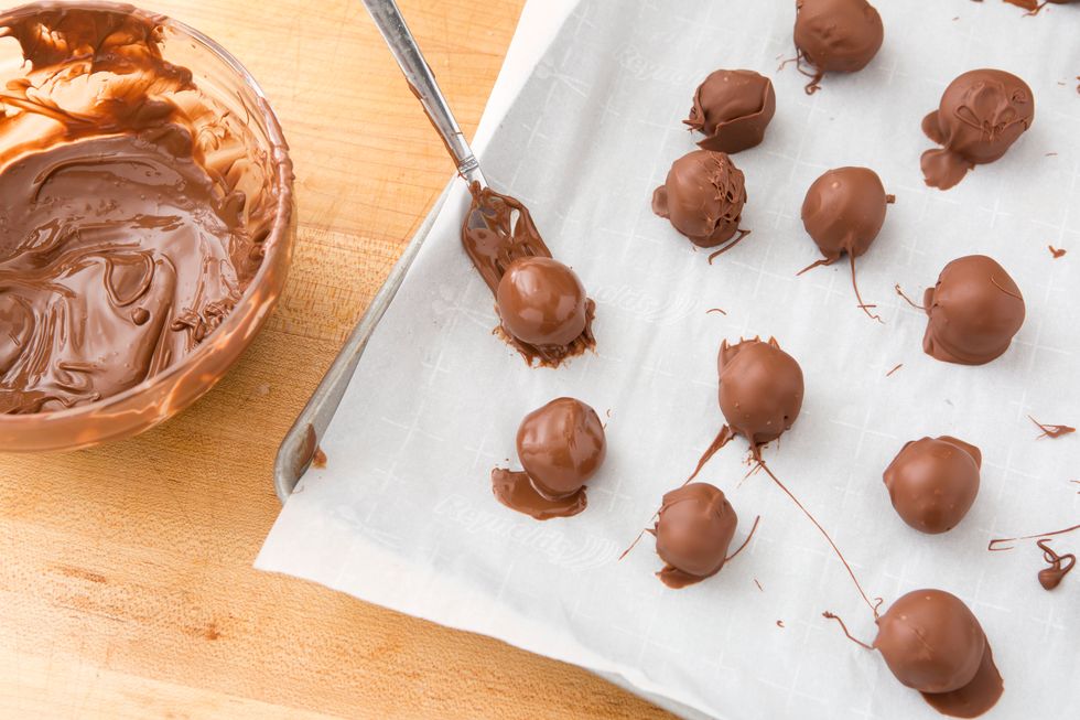 Be sure to tap off any excess coating and put back on the wax paper to set. Stick them in the freeze for 10-15 minutes to speed up the process.