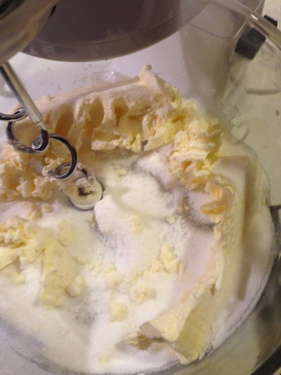 Beat 1 cup of sugar and 1 cup of butter together with a mixer.