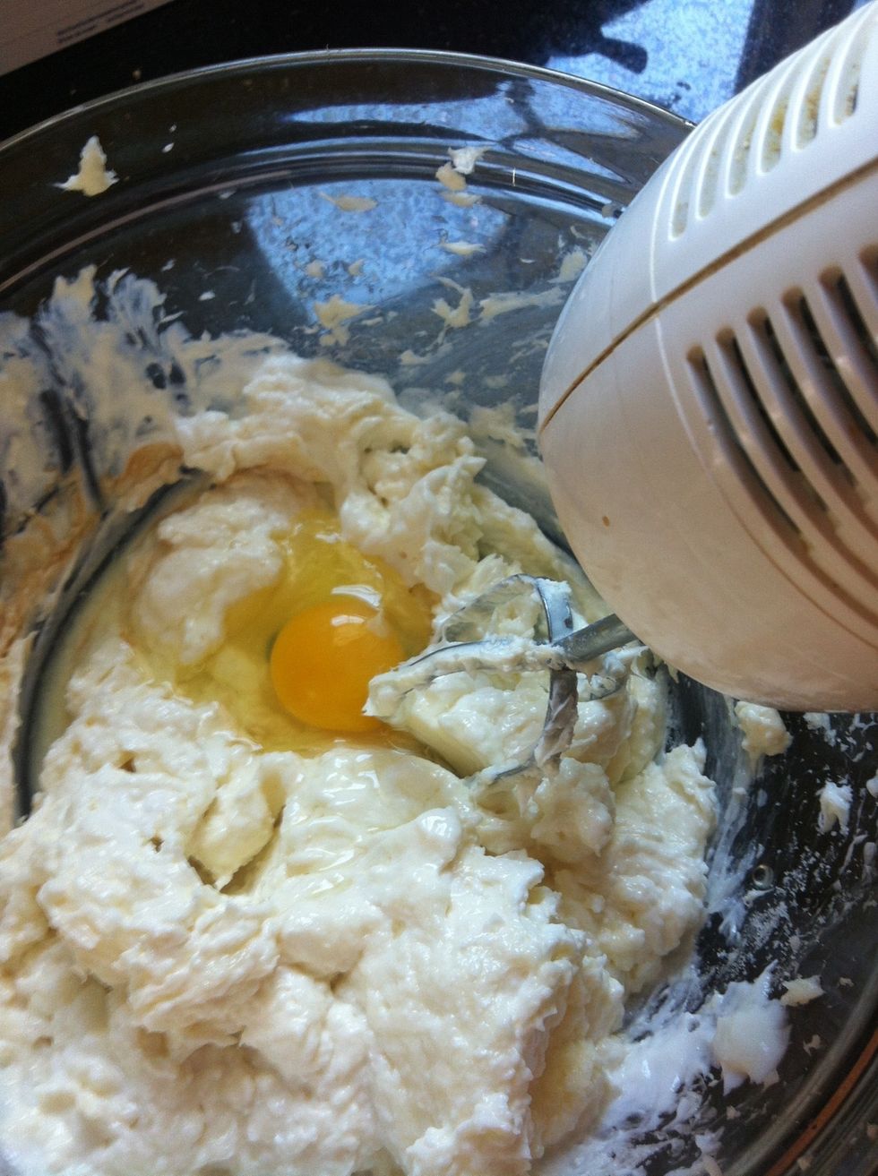 Beat 1 egg at a time. If you're making a larger amount of cheesecakes- there is a rule for 1 egg per 8 oz cream cheese. We use 2 eggs for our 2 packages.